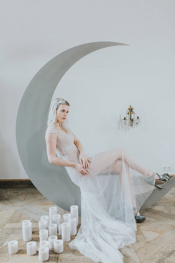 Bride sitting on crescent moon