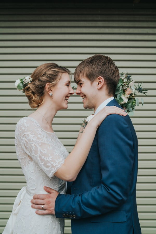 Bride and groom facing each other smiling