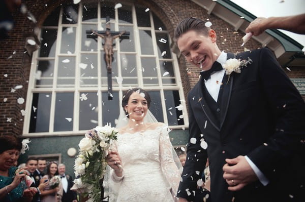 Bride and groom in confetti shower - Picture by Bethany Lloyd-Clarke Photography