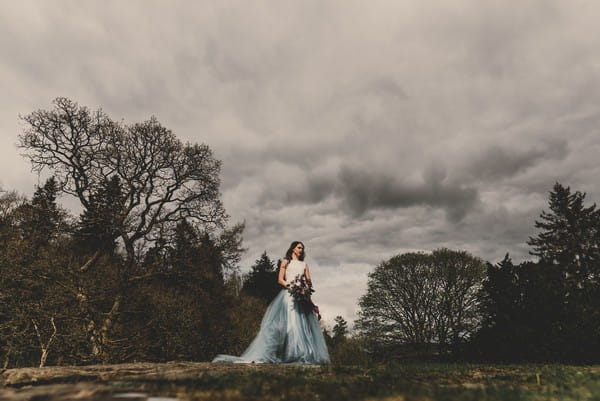 Bride standing on hill in Goyt Valley