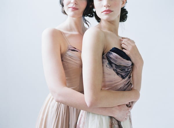 Two brides wearing blush wedding dresses