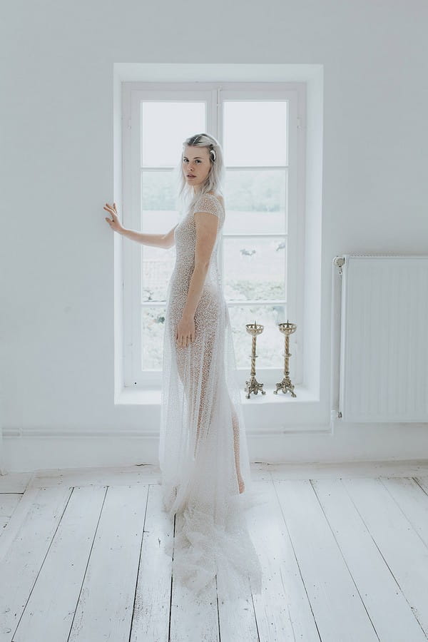Bride standing by window