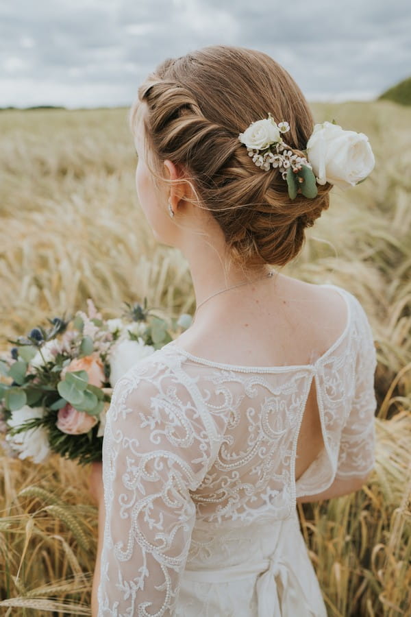 Back view of bride showing updo hairstyle and back of dress