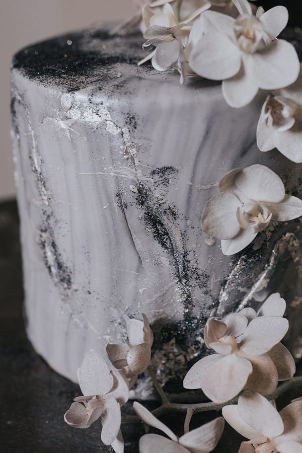 Glitter detail and flowers on celestial wedding cake