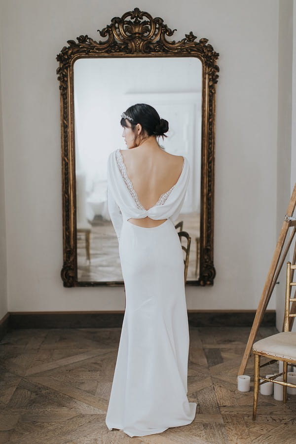 Back of bride showing cowl back of wedding dress