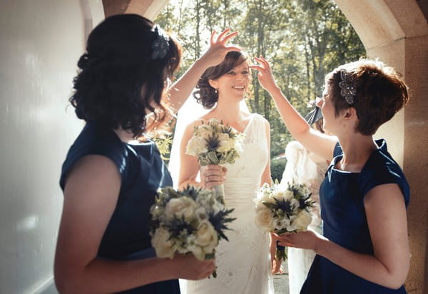 Bridesmaids moving hair from bride's face - Picture by Bethany Lloyd-Clarke Photography
