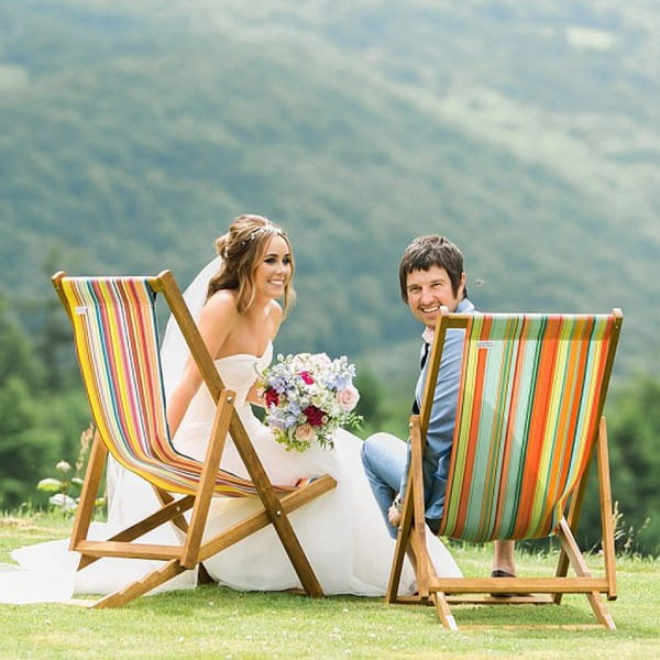 Bride and groom sitting on deckchairs available to hire from from The Prop Factory