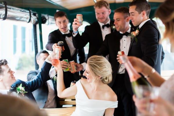 Bridal party toasting on bus