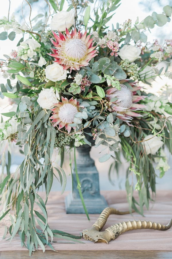 Wedding table display of large flowers and foliage