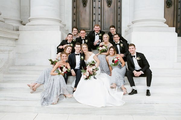 Bridal party sitting on steps of DAR, Washington