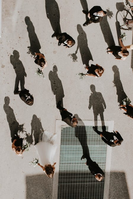 Bridal party standing with shadows showing on ground - Picture by Bows and Lavender