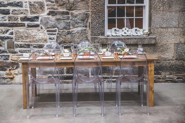 Wooden wedding table with ghost chairs