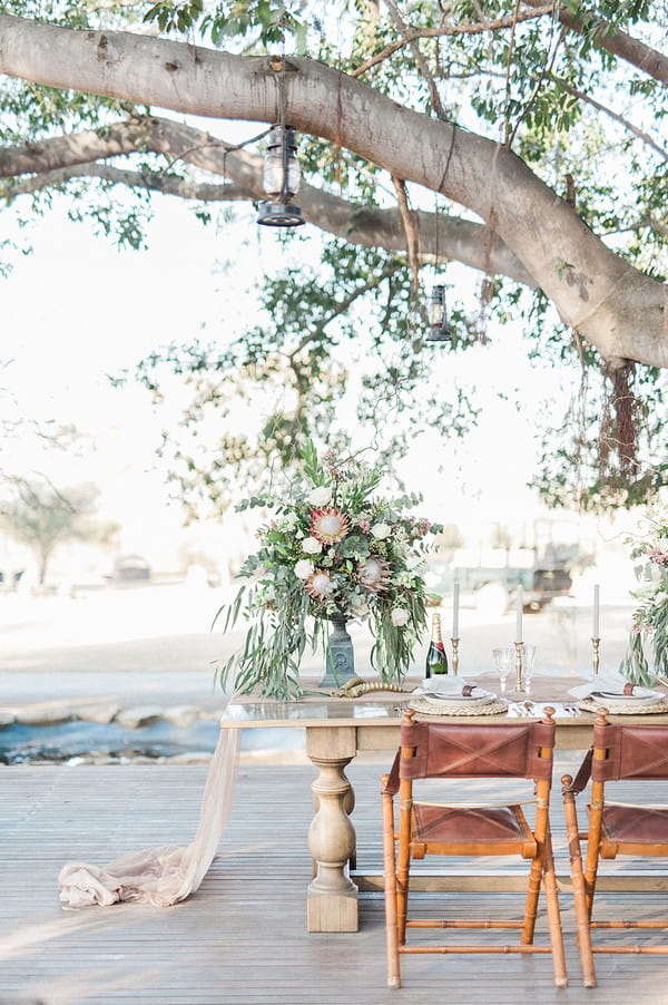 Small wedding table under tree at Nambiti Private Game Reserve