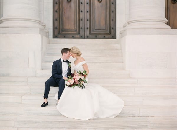 Bride and groom sitting on steps of DAR, Washington