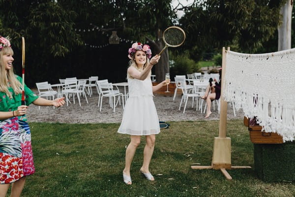 Bride-to-be playing badminton on hen party