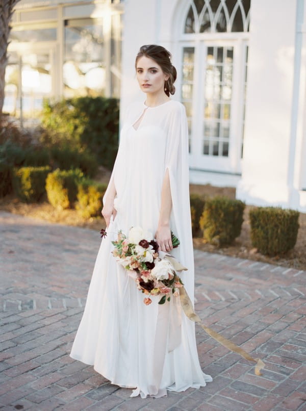 Bride holding bouquet by her side