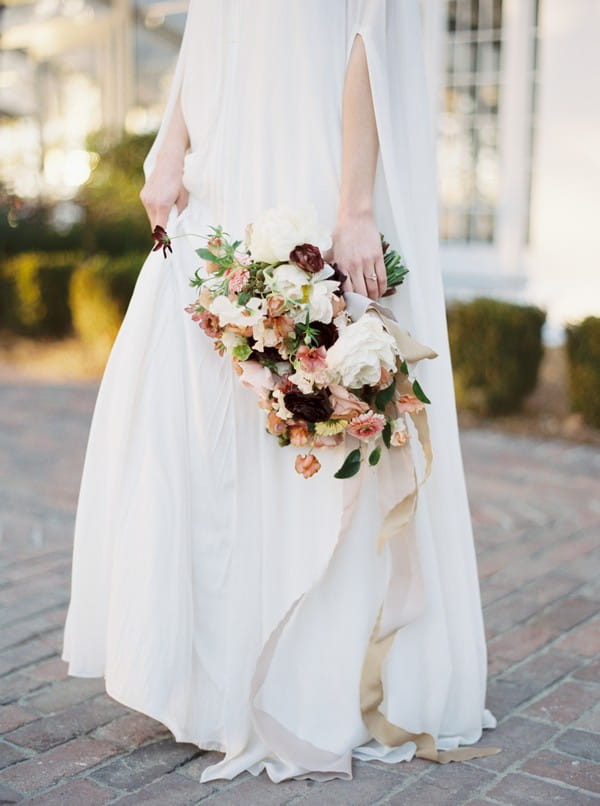 Pink bridal bouquet by bride's side