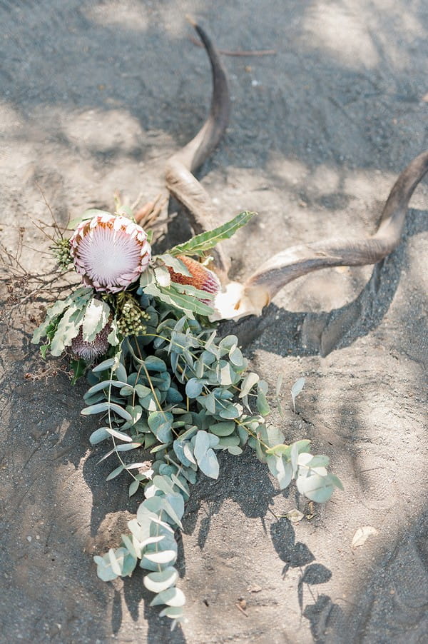 Bridal bouquet with large flower and lots of foliage on ground