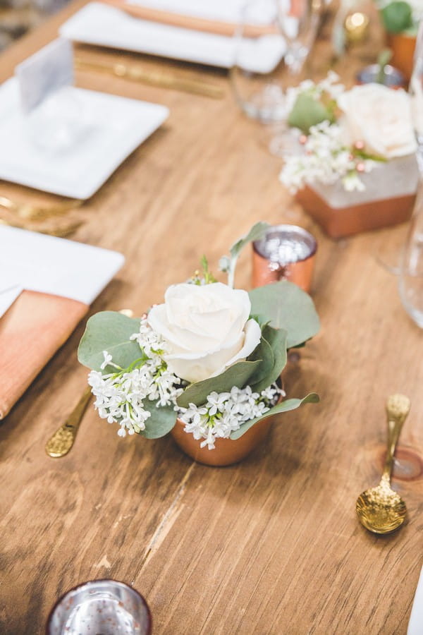 Small pot of white wedding table flowers