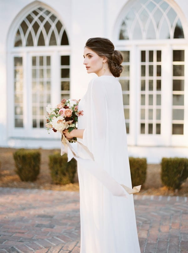 Bride wearing long cape