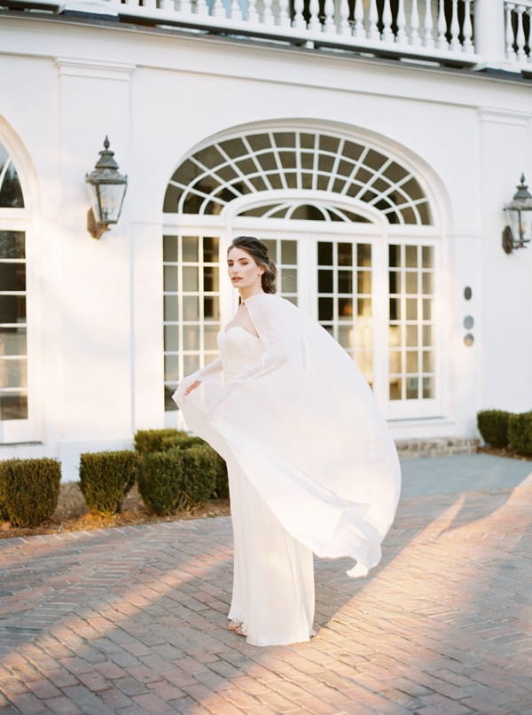 Bride's cape blowing in wind