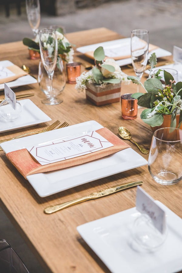 Copper wedding styling on wooden table