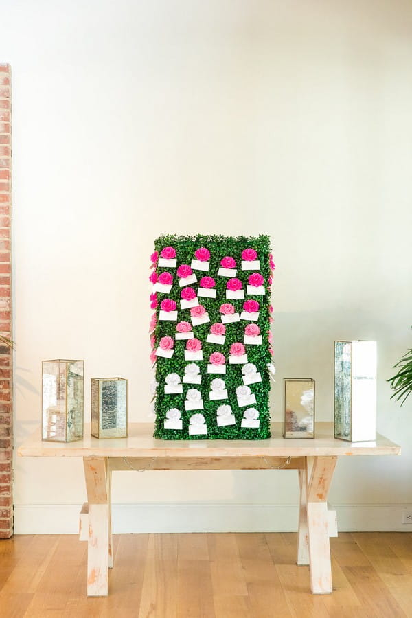 Escort cards attached to flowers on foliage box