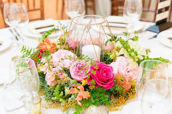 Bright, colourful wedding table flowers