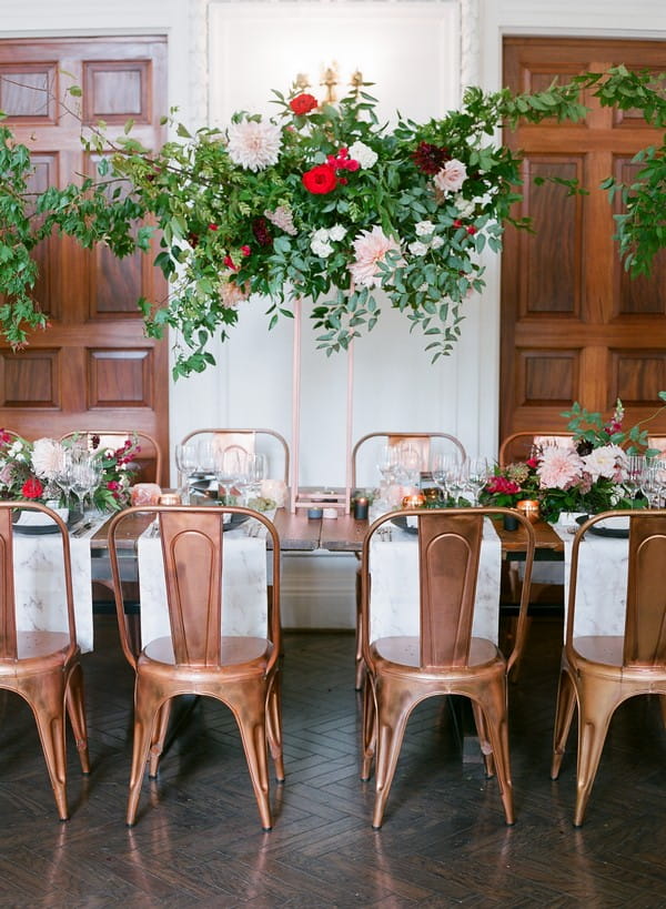 Floral display hanging over wedding table