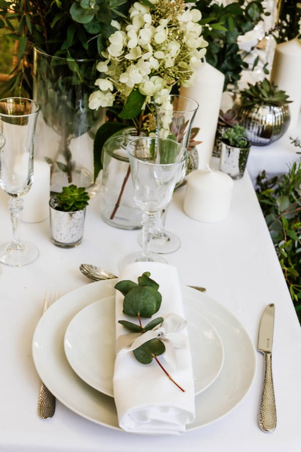 Wedding place setting with eucalyptus leaves