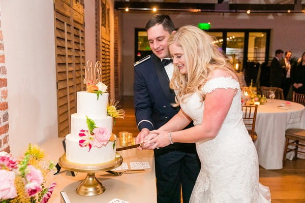 Bride and groom cutting wedding cake