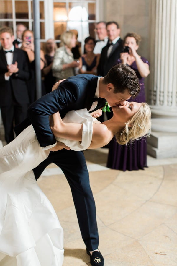 Bride and groom leaning kiss on dance floor