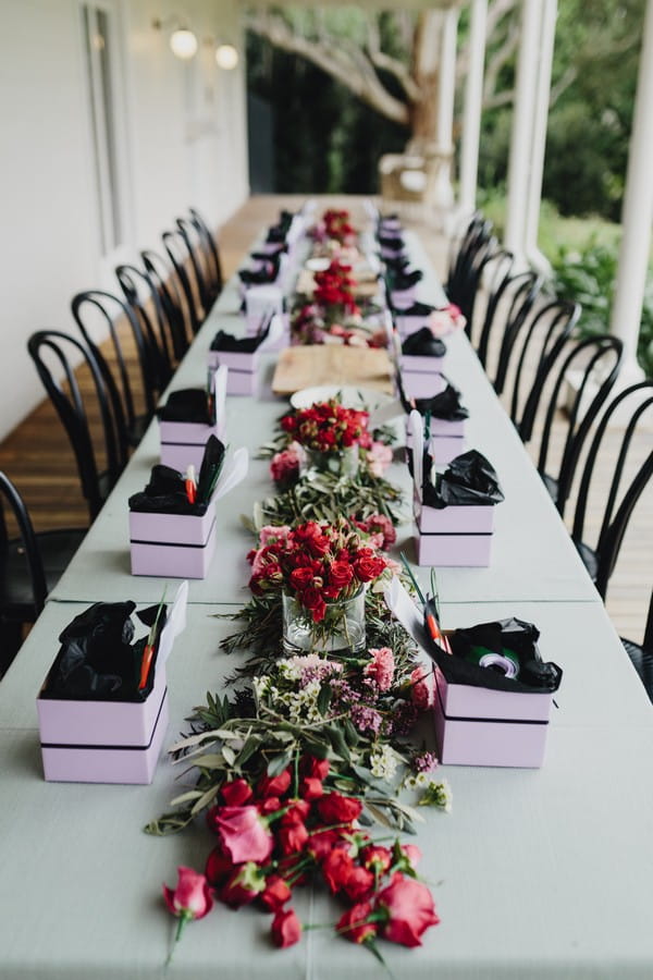 Long table with items needed to make flower crowns