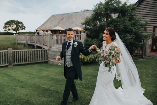 Bride and groom in grounds of Sandhole Oak Barn