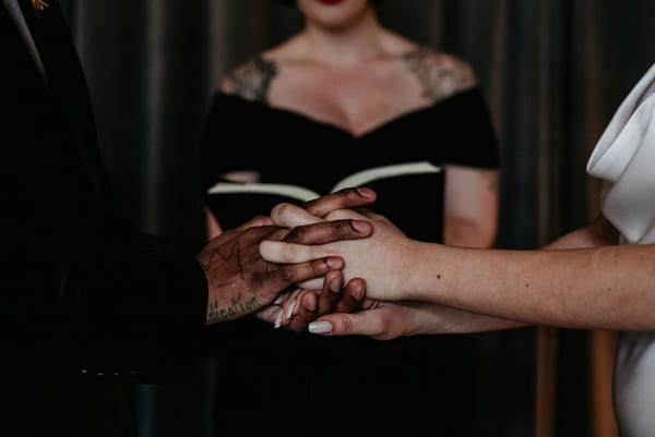 Bride and groom holding hands during elopement ceremony