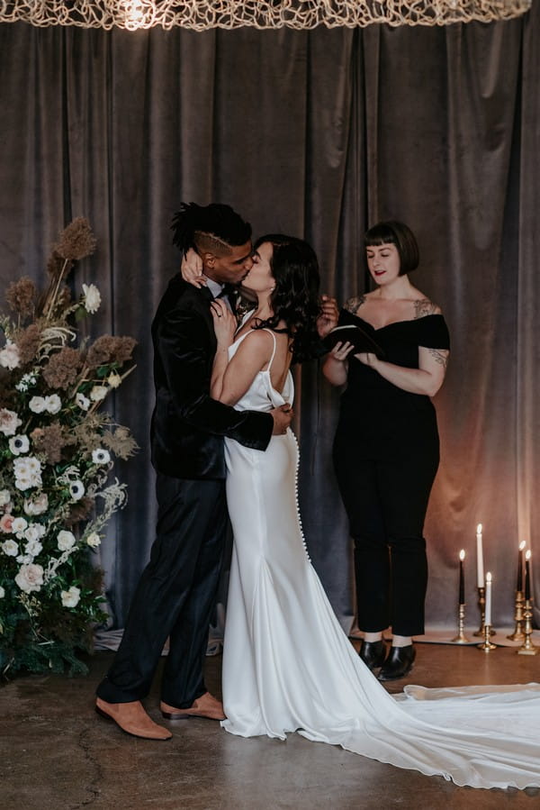 Couple kissing after being pronounced husband and wife