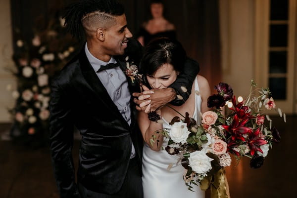 Bride kissing groom's hand as they leave elopement ceremony