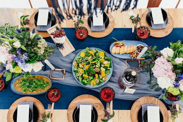 Aerial view of food on wedding table with blue and copper details