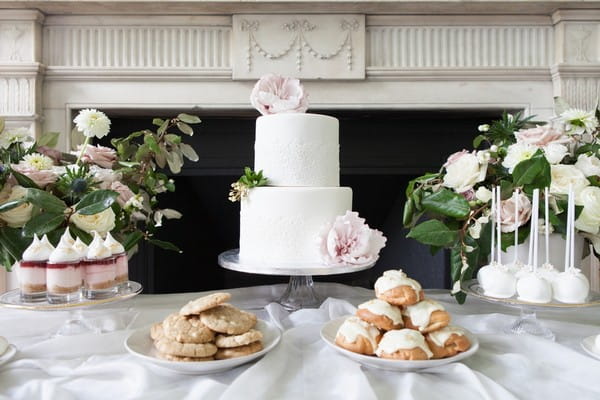 White wedding cake, cookies and profiteroles