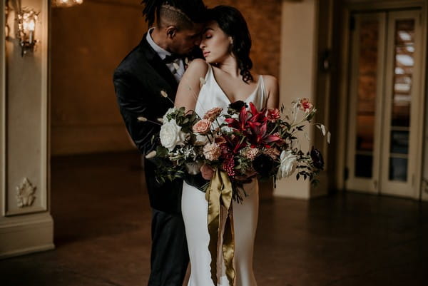 Bride and groom touching heads