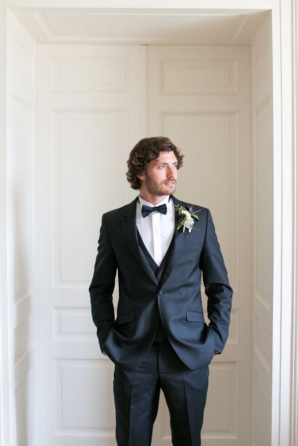 Groom with hands in pockets