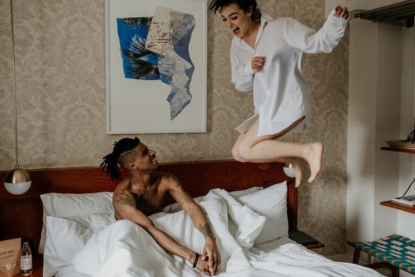 Excited bride to be jumping on bed