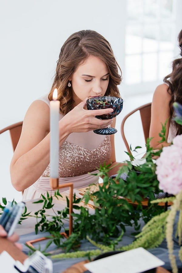 Wedding guest lifting starter up to her nose