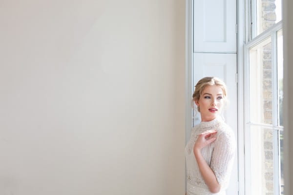 Bride standing by window at Clissold House