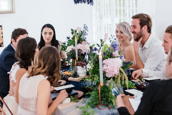 Guests sitting at small table for intimate wedding breakfast