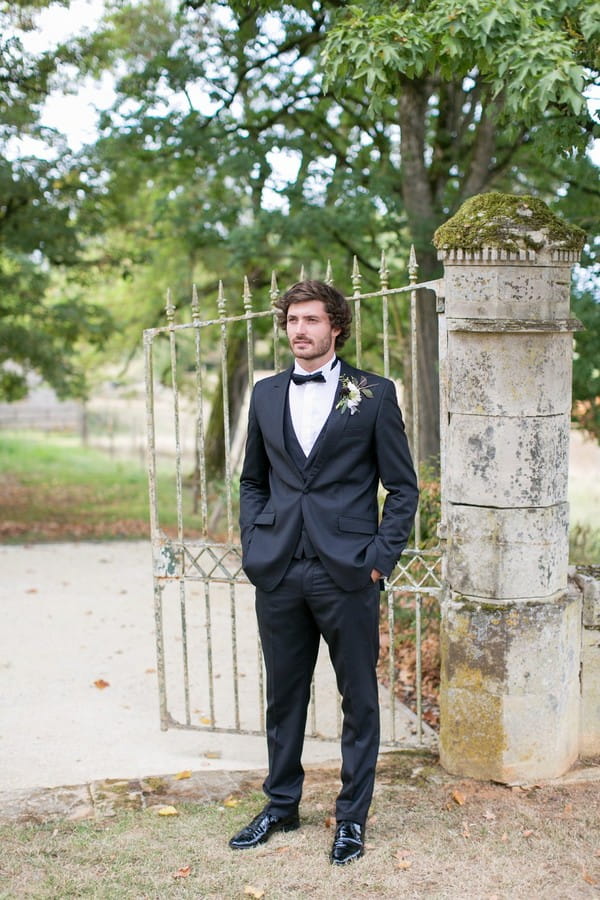 Groom waiting for bride at gates of Chateau de Redon