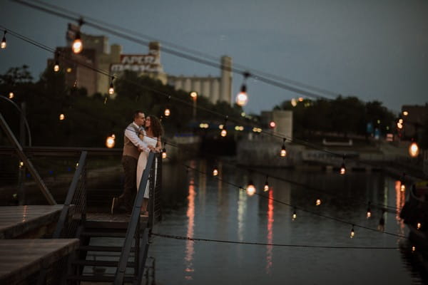 Bride and groom about to kiss on steps by river - Picture by Gabrielle Desmarchais