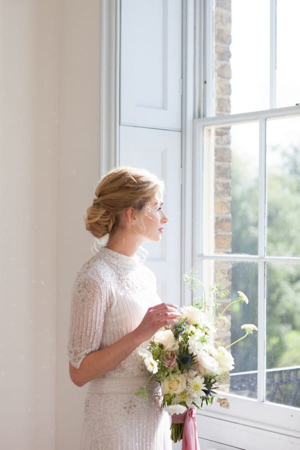 Bride looking out of window at Clissold House