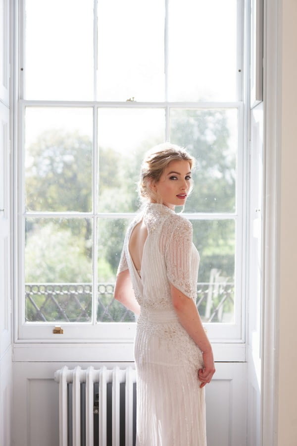 Bride standing by window at Clissold House