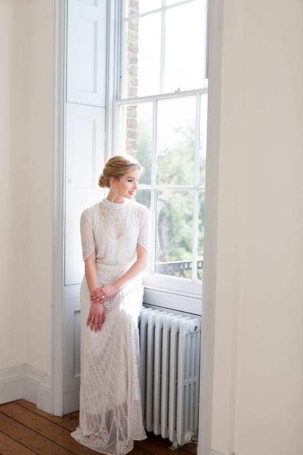 Bride sitting by window at Clissold House